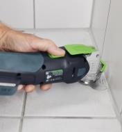 Removing caulking from bathroom tiles using an oscillating tool with a silicone blade attached