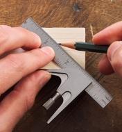 Using a pencil and a 4" combination square to mark the line for a miter cut on a wooden workpiece