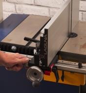 Adjusting for bandsaw drift by turning a knob on a DX3 Driftmaster bandsaw fence