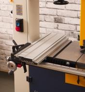 A Laguna DX3 Driftmaster bandsaw fence mounted on a bandsaw table in the horizontal orientation