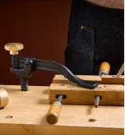 The Veritas Hold-Down clamping wooden handscrews on a workbench