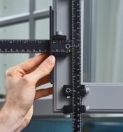 A cupboard door with a cabinet hardware jig positioned vertically