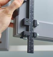 Positioning a cabinet hardware jig at the corner of a cupboard