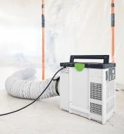 A Festool LS-SYS-AIR D 200×6m Air Supply Hose extending from behind a dust protection wall and attached to an air purifier