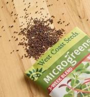 Three-week blend microgreen seeds scattered on a wood surface