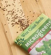 Broccoli microgreen seeds scattered on a wood surface