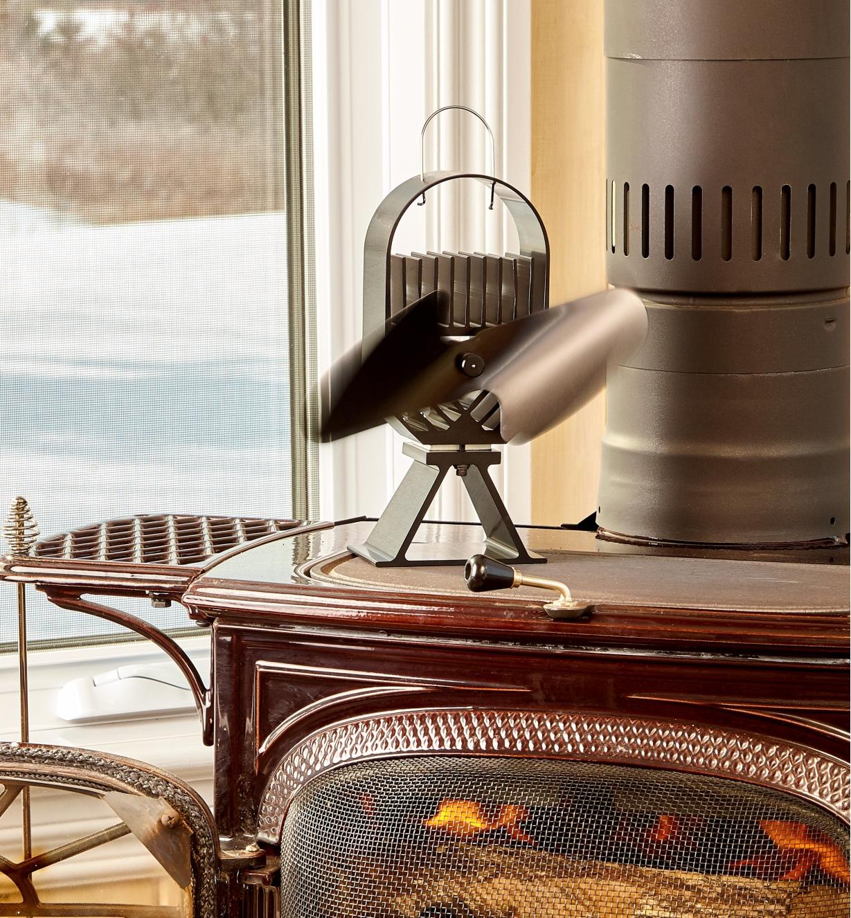 Large Ecofan AirDeco on a wood stove, distributing the heat of the fire