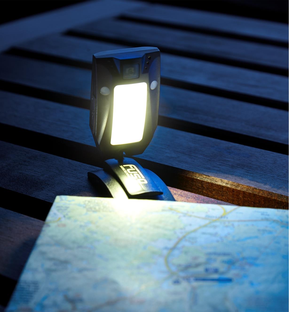 Detached from the band, the base of the multi-function LED headlamp is used freestanding
