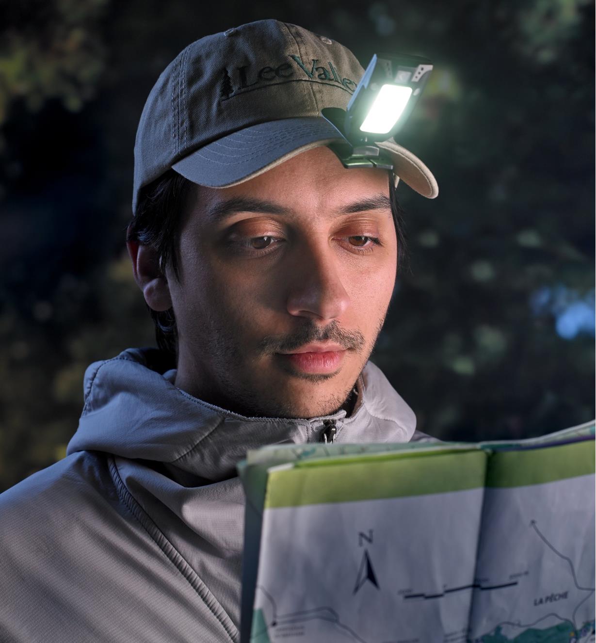 Reading a map in low light with the multi-function LED headlamp clipped to a cap brim