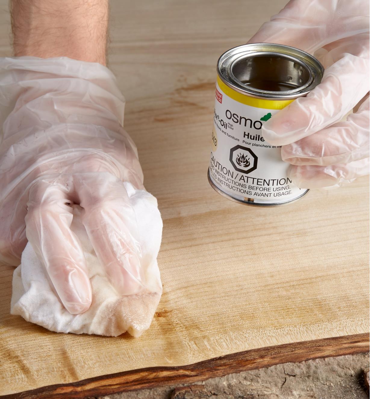 Wiping Osmo Polyx hard wax oil onto wood using a cloth
