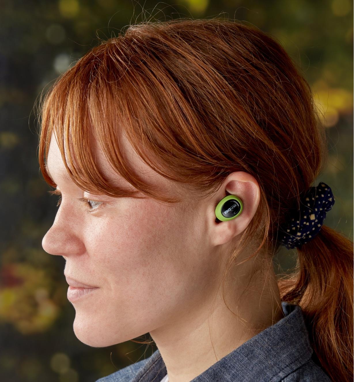 A woman wearing ISOtunes Free wireless electronic hearing protectors