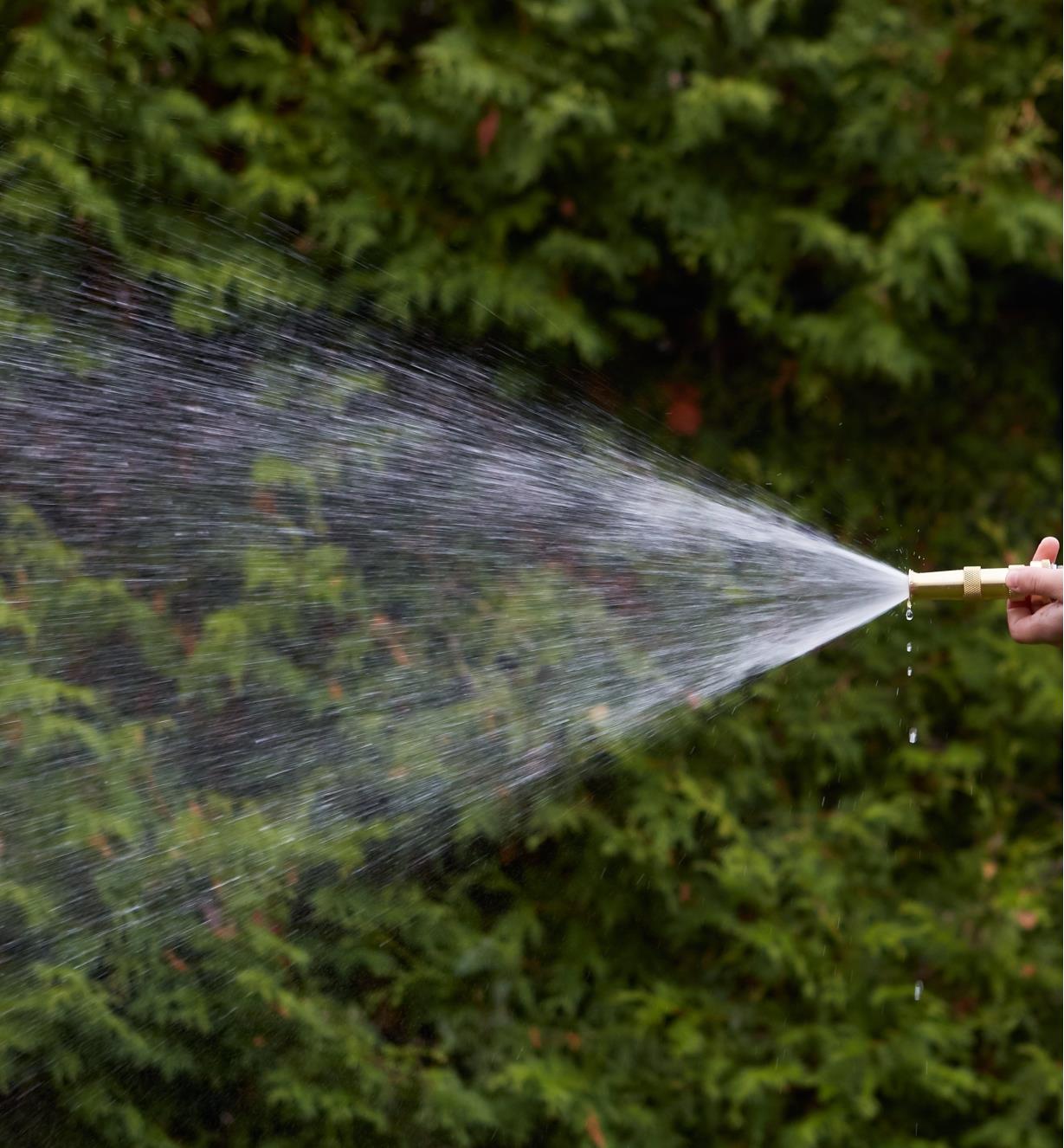 Brass Hose Nozzle spraying a medium stream of water