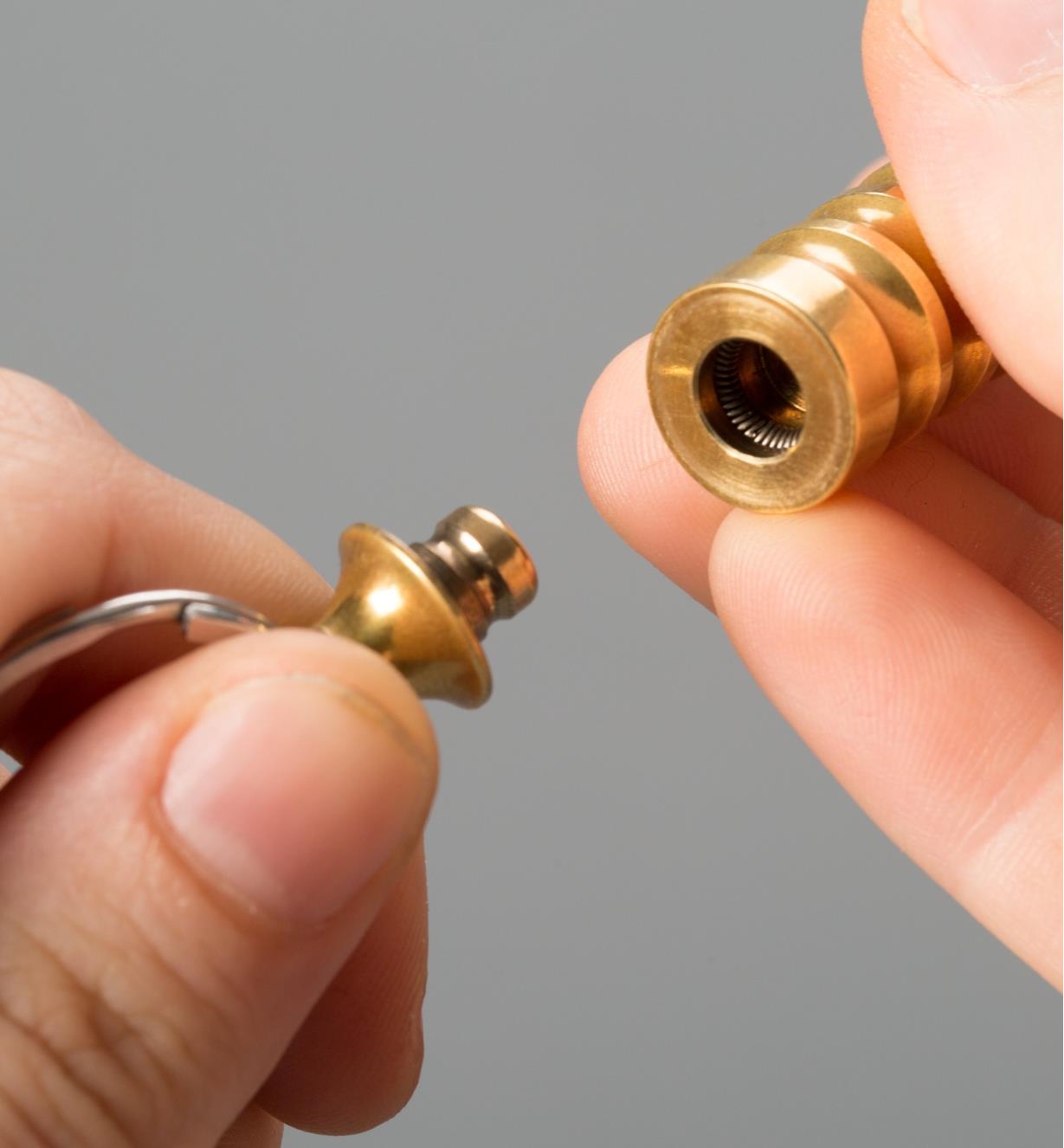 Detaching the brass flashlight from the key ring
