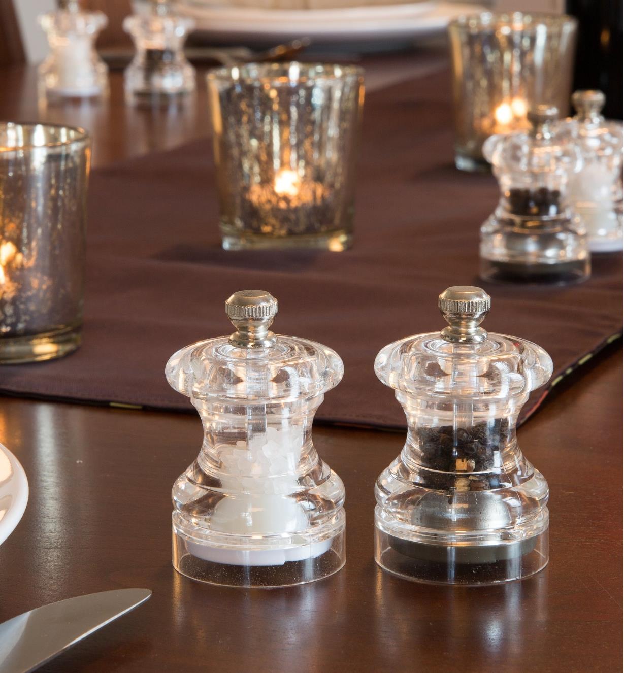 Cole & Mason Mini Salt & Pepper Mills on a dining table with candles behind