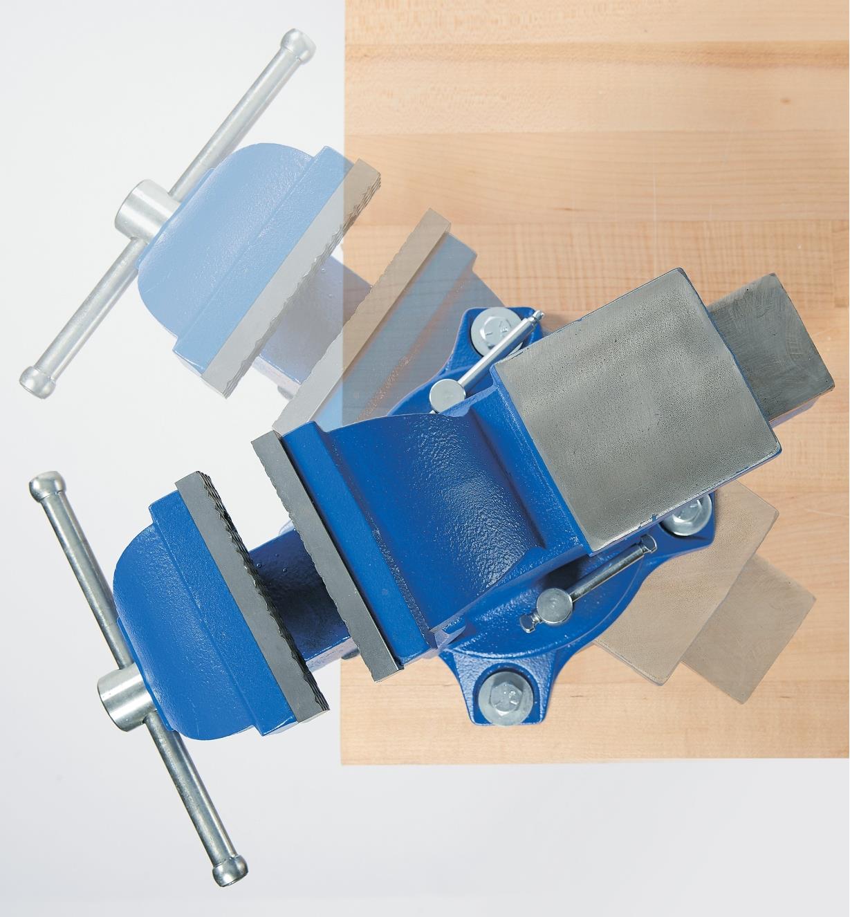Top view of heavy-duty vise with ghosted image showing swivel action