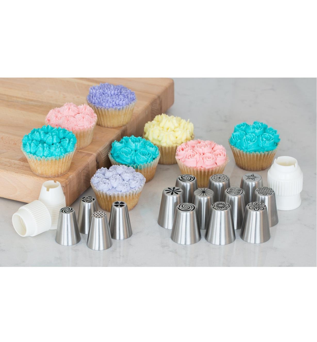 Decorative Piping Tips on a counter with samples of cupcakes frosted using the tips