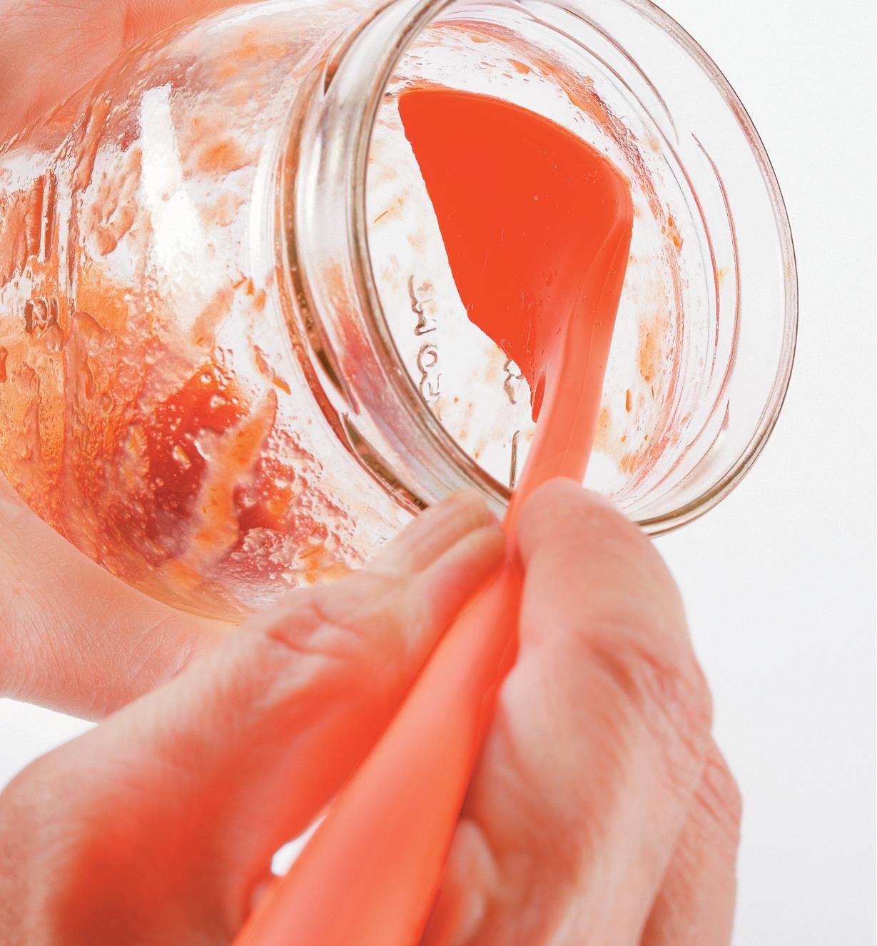 Using the Small Silicone Spatula to scrape jam from the sides of a jar