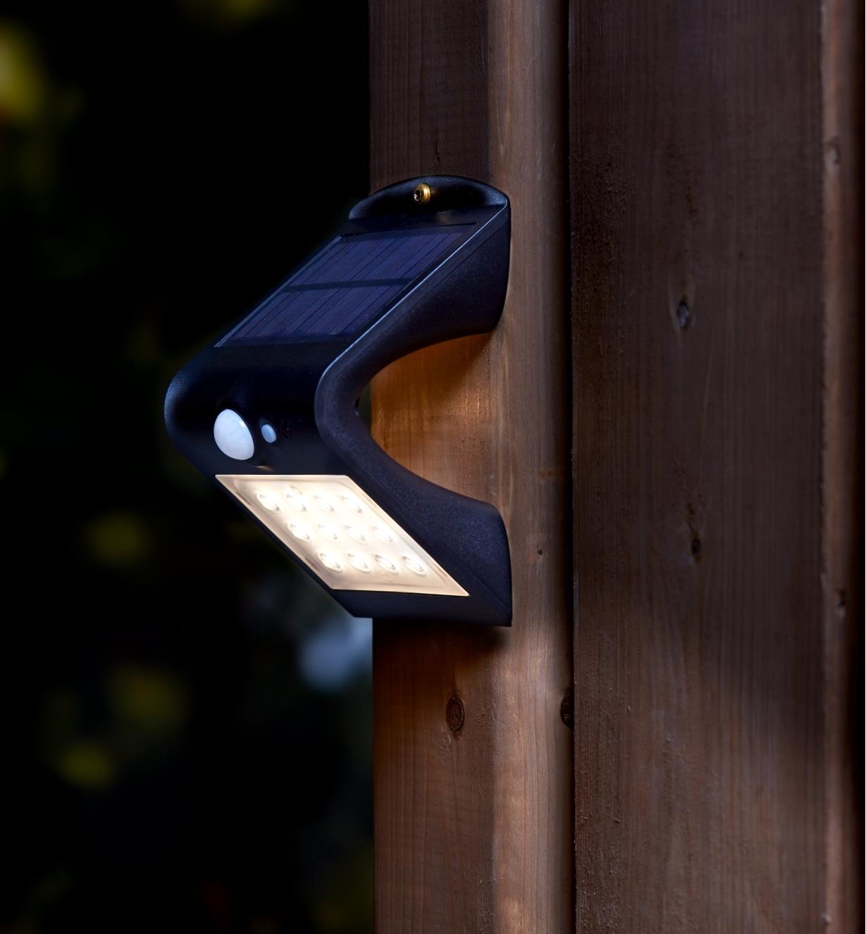 Motion-Sensing Solar LED Light mounted on a fence