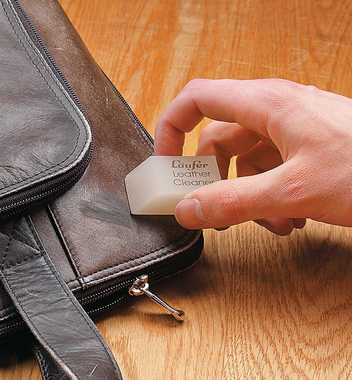 Using the leather eraser to clean a briefcase