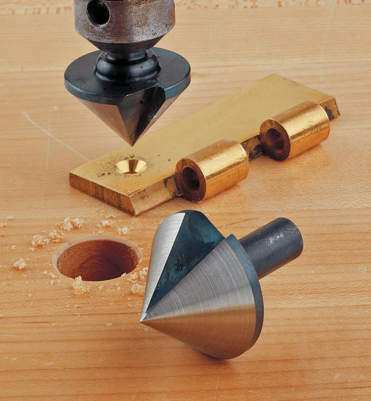 An 82° countersink in a drill press being used to chamfer a hole