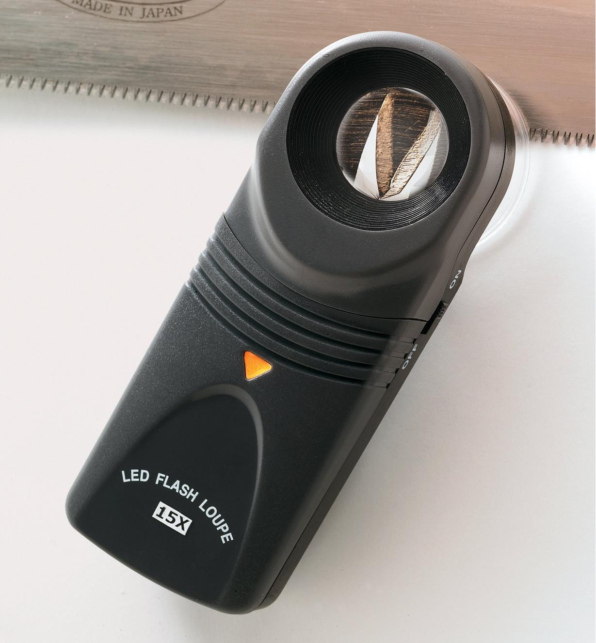 Using a 15-Power Lighted Loupe to examine saw teeth