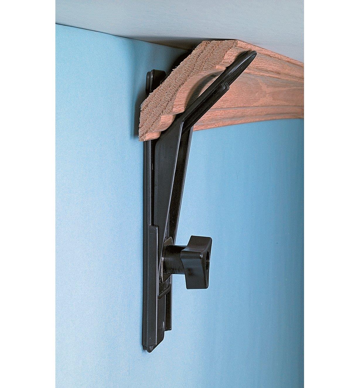 Crown Molding Hanger holding molding in position against a ceiling