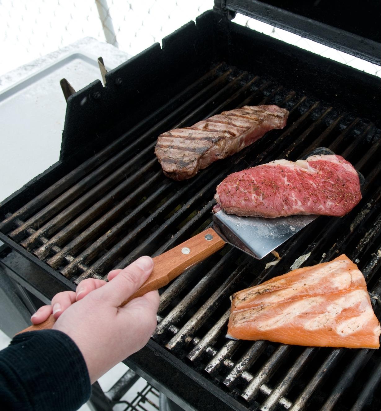 Using the Barbecue Grill Spatula to flip a steak on a grill