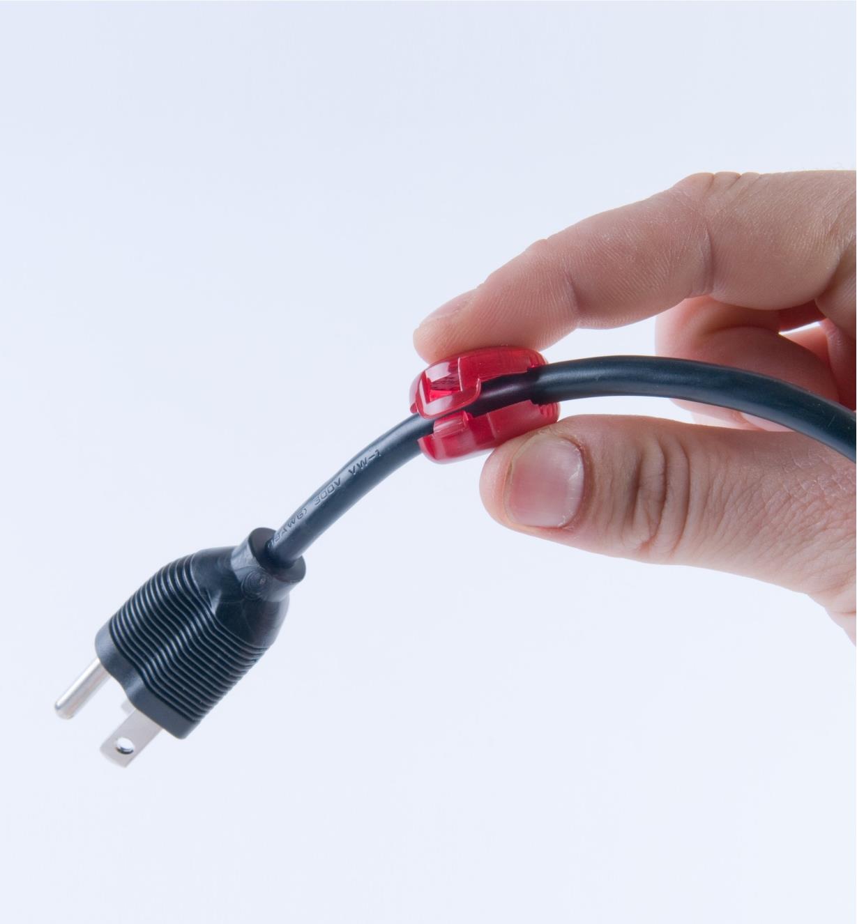 Small cord identifier clipped near the plug end of a power cord
