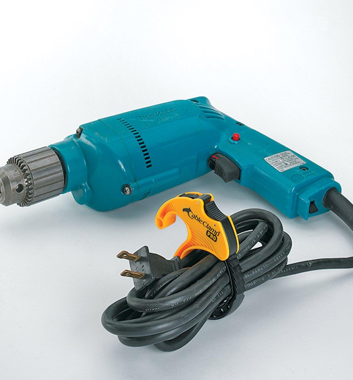 Looped electric drill cord secured by a medium CableClamp