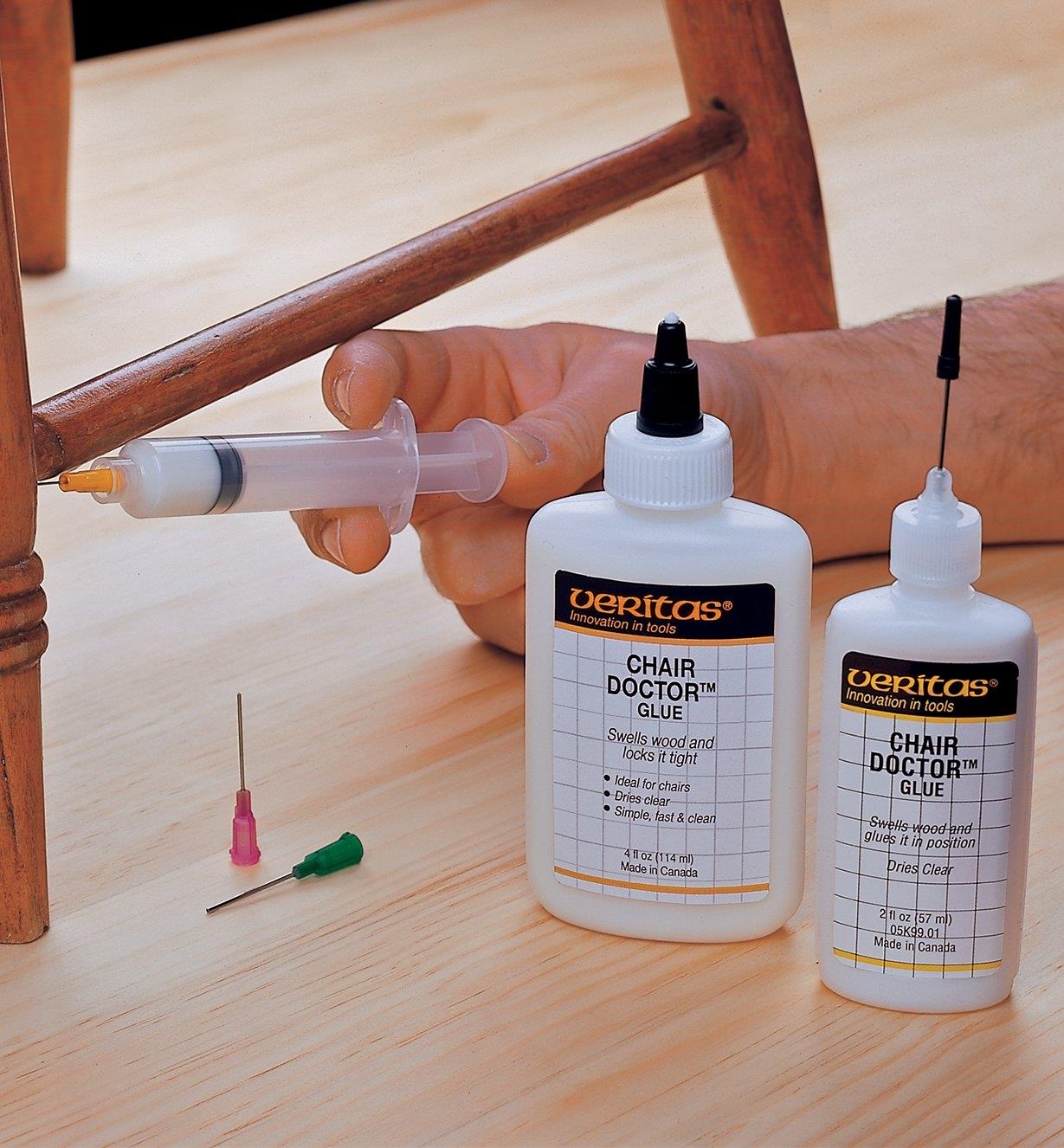 Injecting Chair Doctor glue into a chair joint beside bottles of glue in both sizes