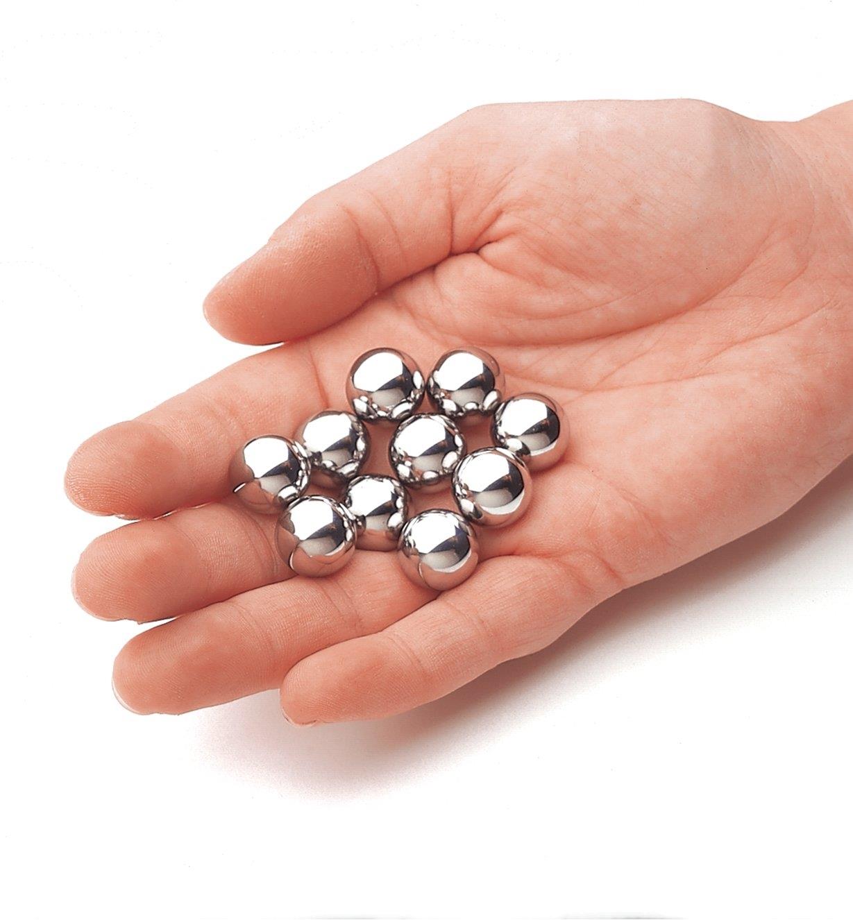 10 chromed steel balls in the palm of a hand