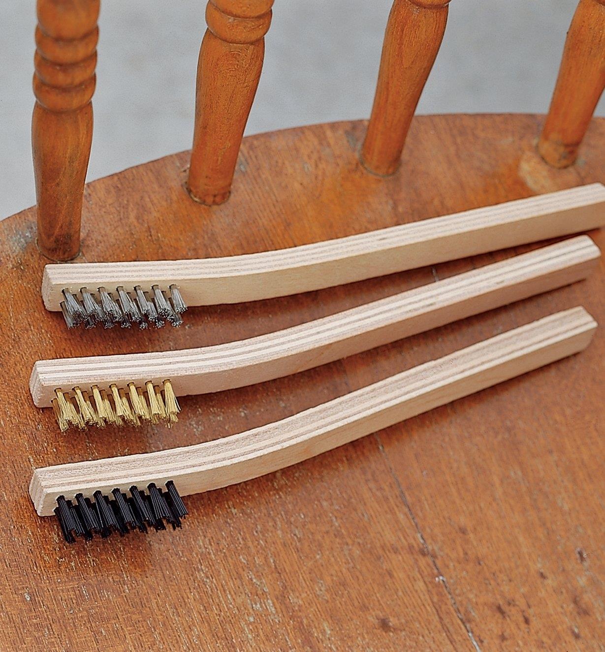 Set of 3 Brushes placed on a wooden chair seat