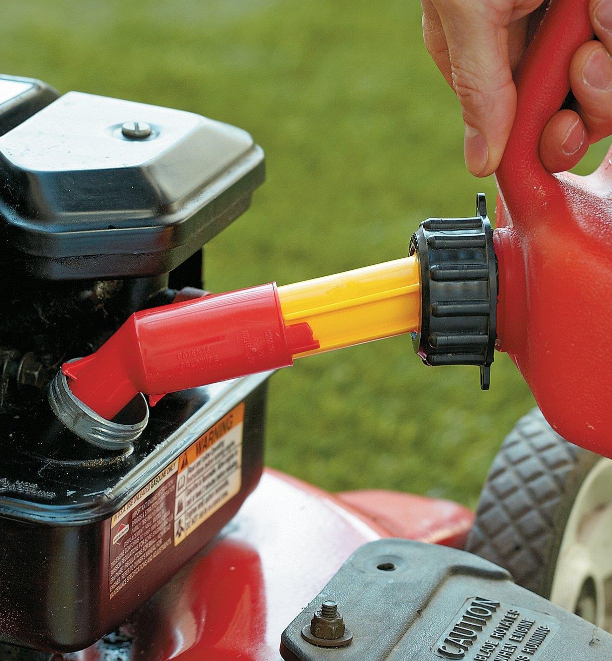 Filling a lawnmower from a fuel container using the auto shut-off spout