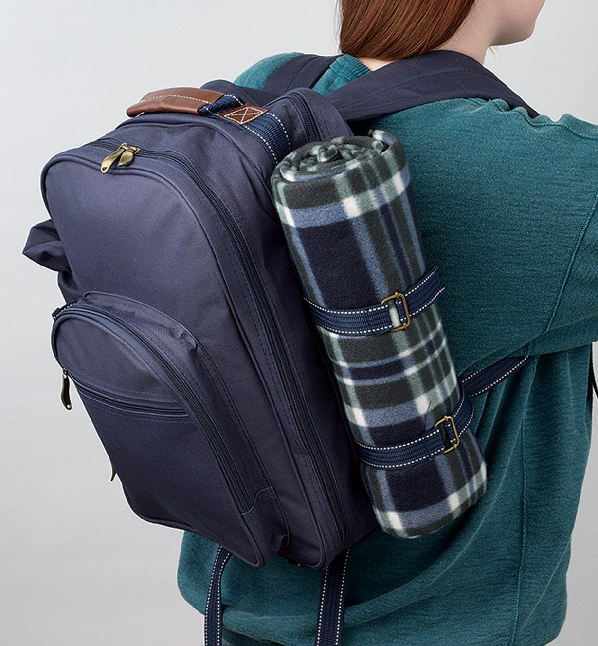 A woman carrying the Deluxe Picnic Backpack on her back