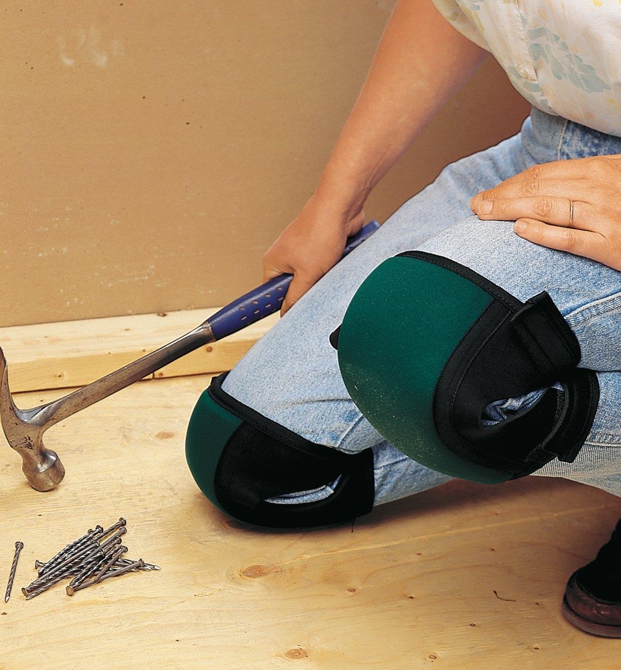 A woman wearing Contoured Knee Pads while doing construction