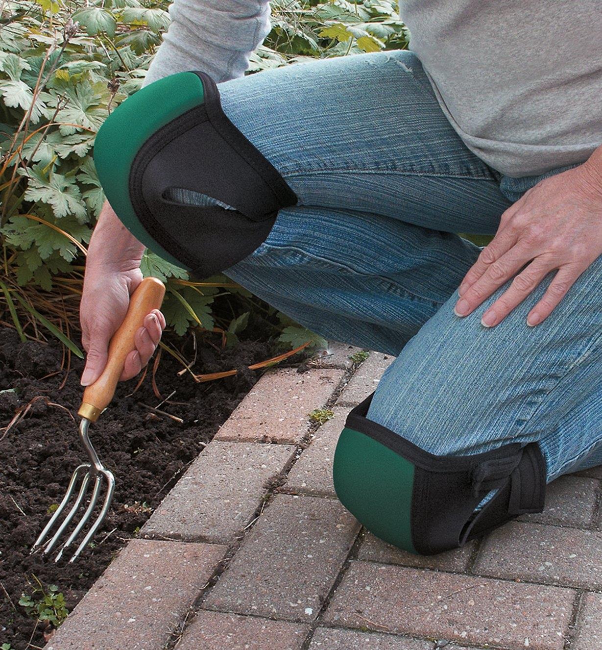 A woman wearing Contoured Knee Pads while gardening