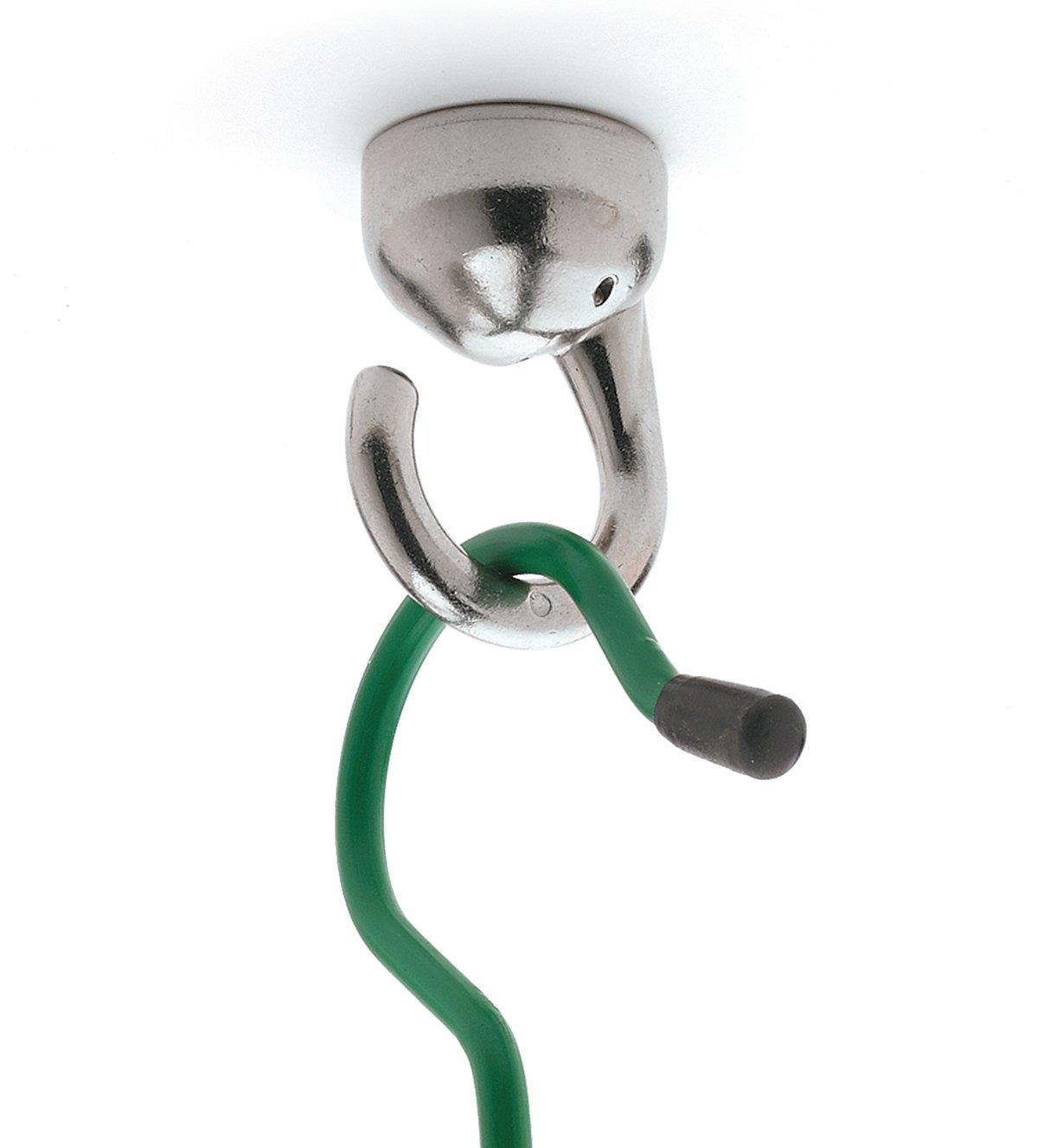 A garden hook hanging from an installed Nickel-Plate Elephant Ceiling Hook