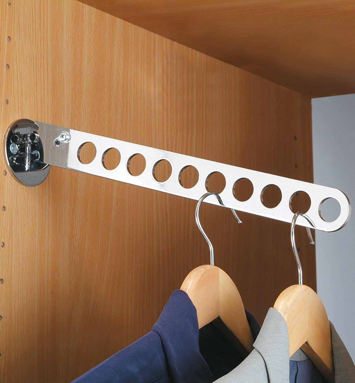 Folding Hanger Rack installed in a closet, holding two shirts on hangers