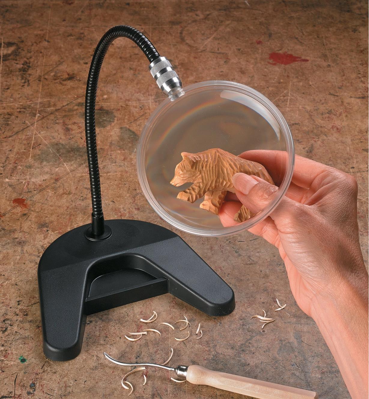 Flex-Neck Desk Magnifier used to magnify a small bear carving