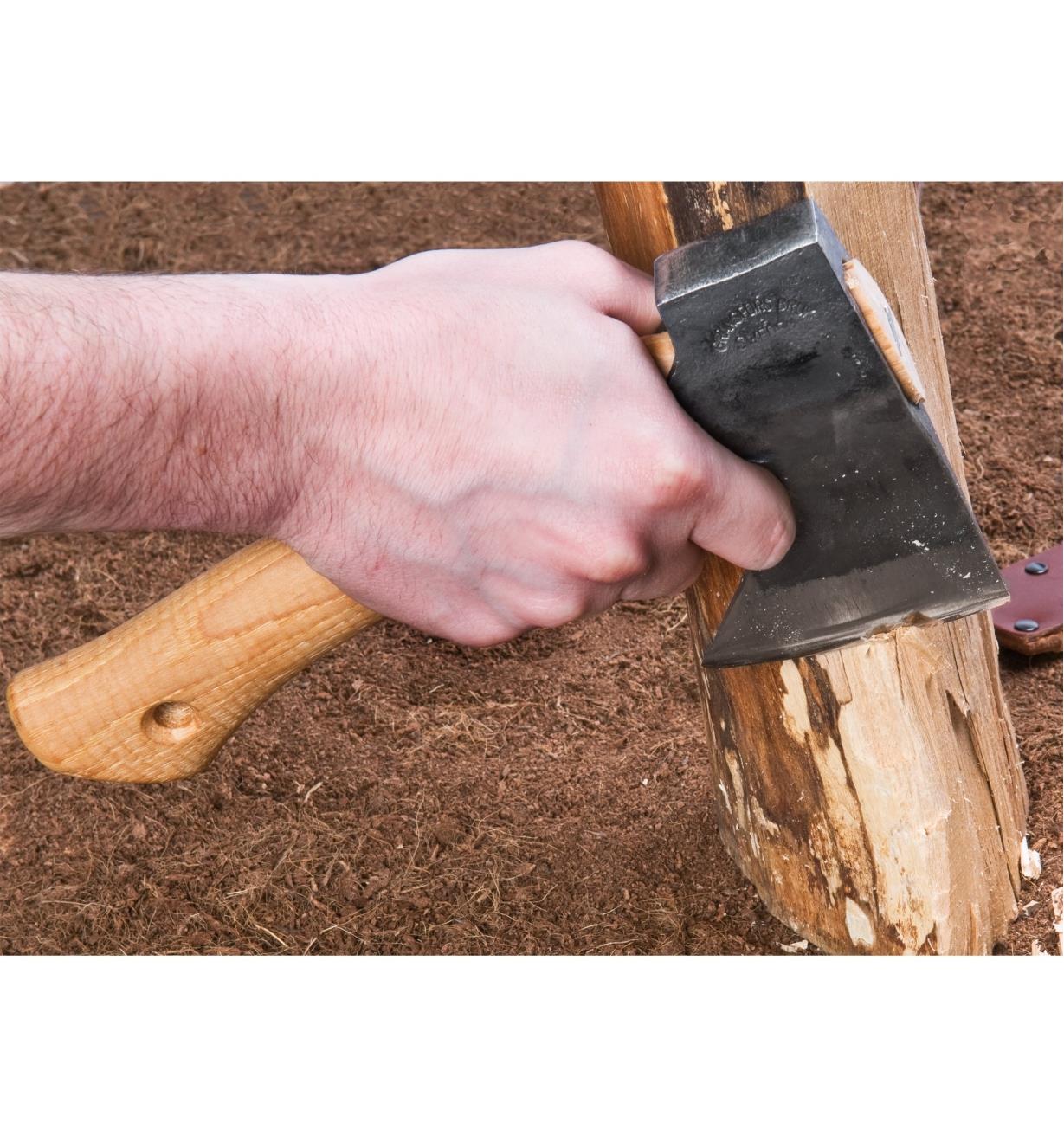 Using a Gränsfors Small Carving Axe to remove bark from a log
