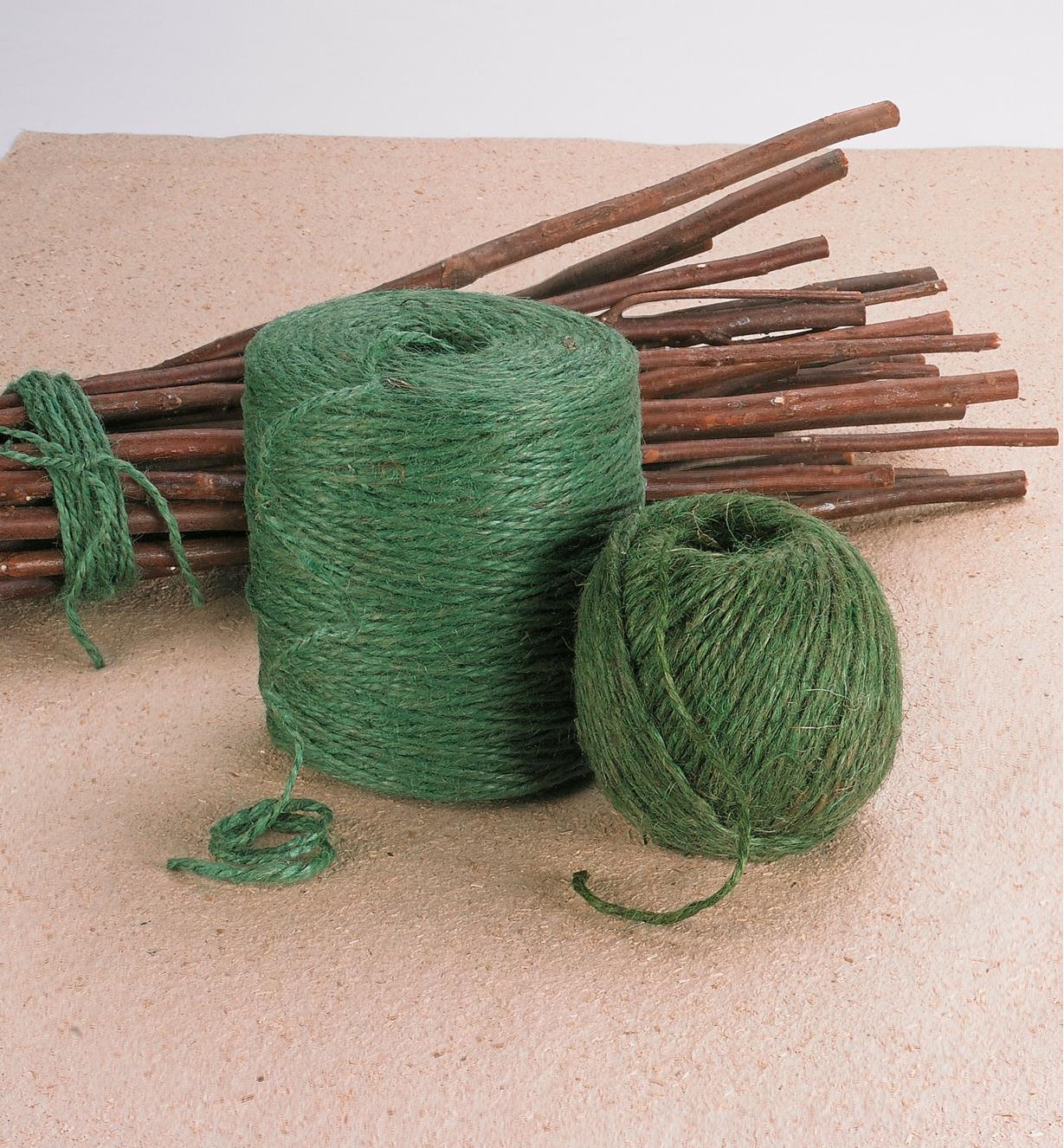 Two balls of Garden Twine beside a bundle of stick tied with twine