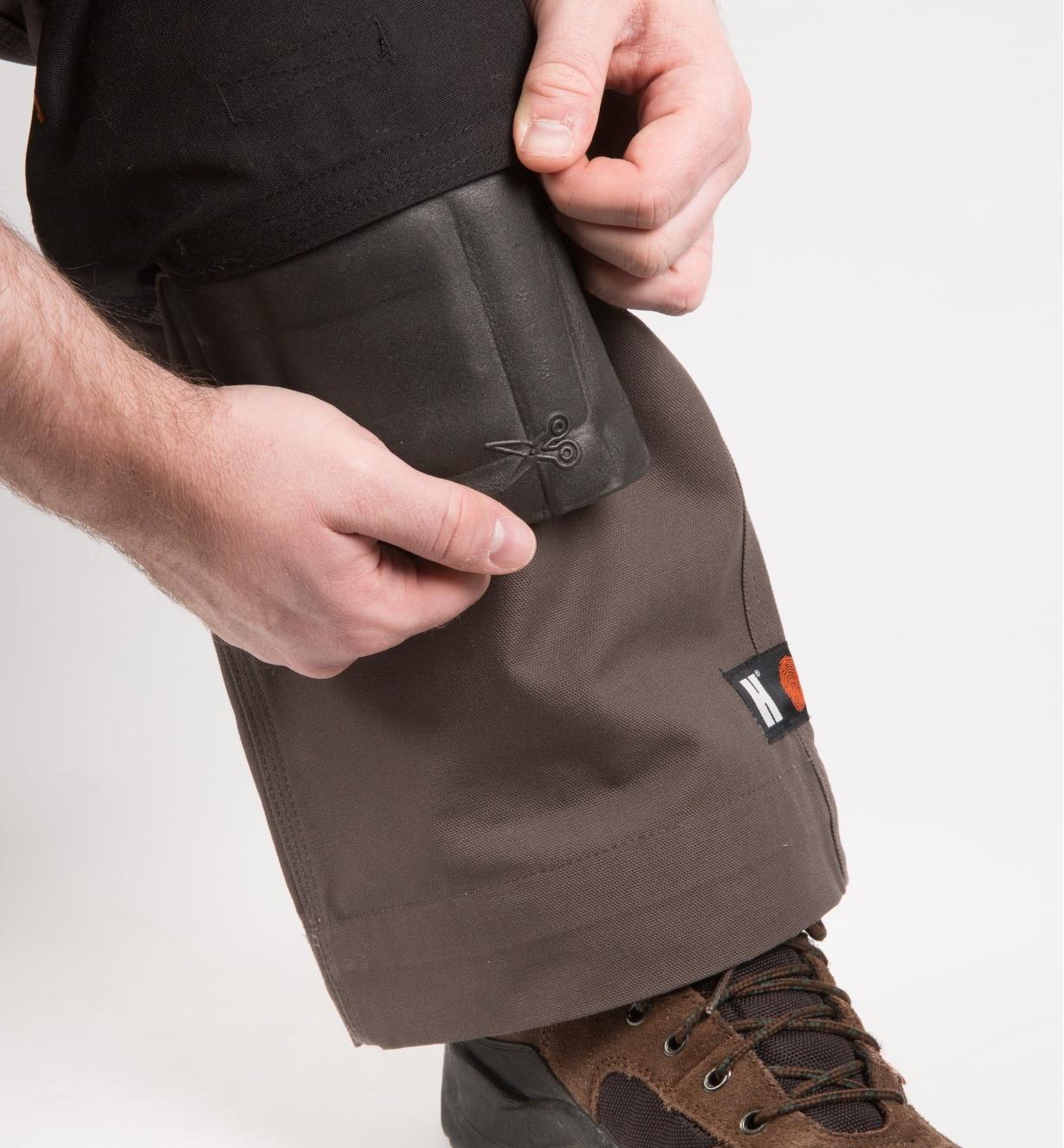 Inserting the knee pad in the pocket of the Gray Heavyweight Pants