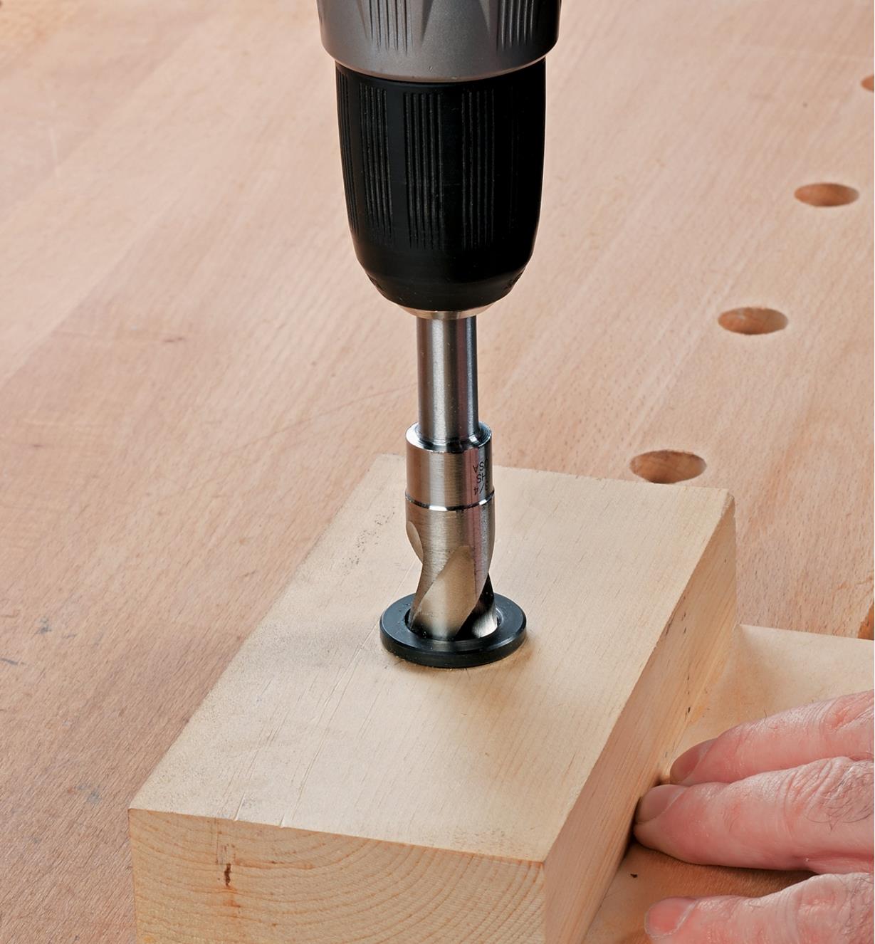 Drilling a hole using a drilling guide made with dog hole bushing