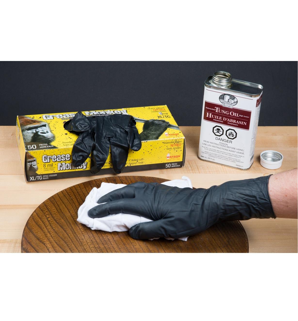 Wearing Grease Monkey Nitrile Gloves while applying tung oil to wood