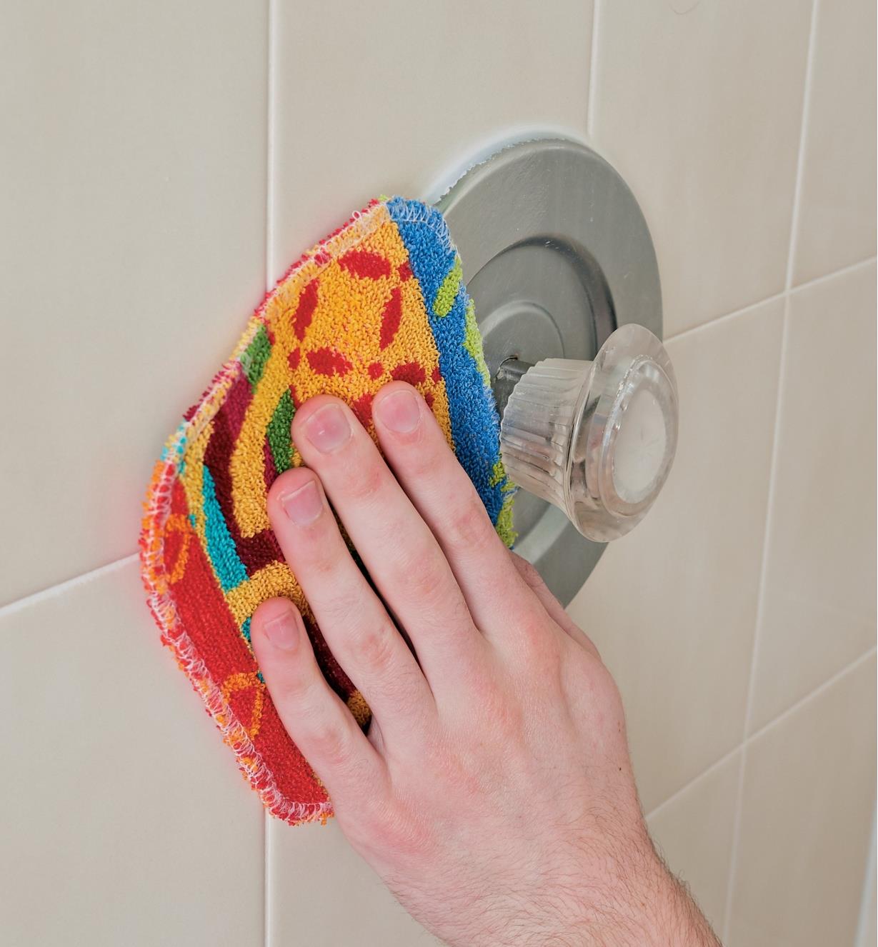Using the Euroscrubby Scouring Pad to clean a shower faucet