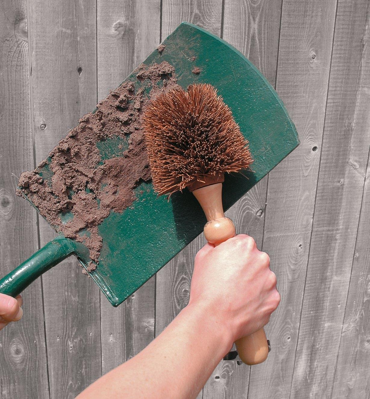 Cleaning a spade with the Heavy-Duty Brush
