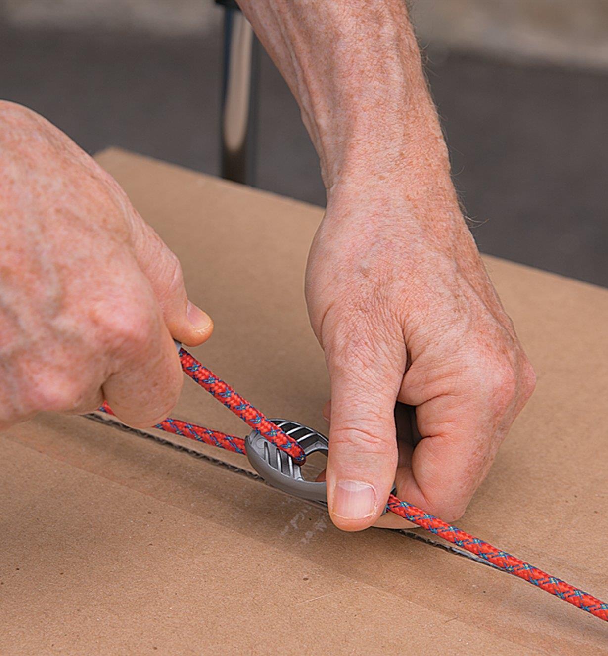Tightening a Loopable Bungee around a cardboard box