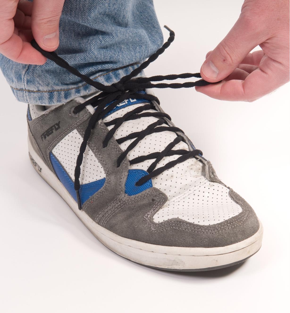 Tying a lace on a running shoe