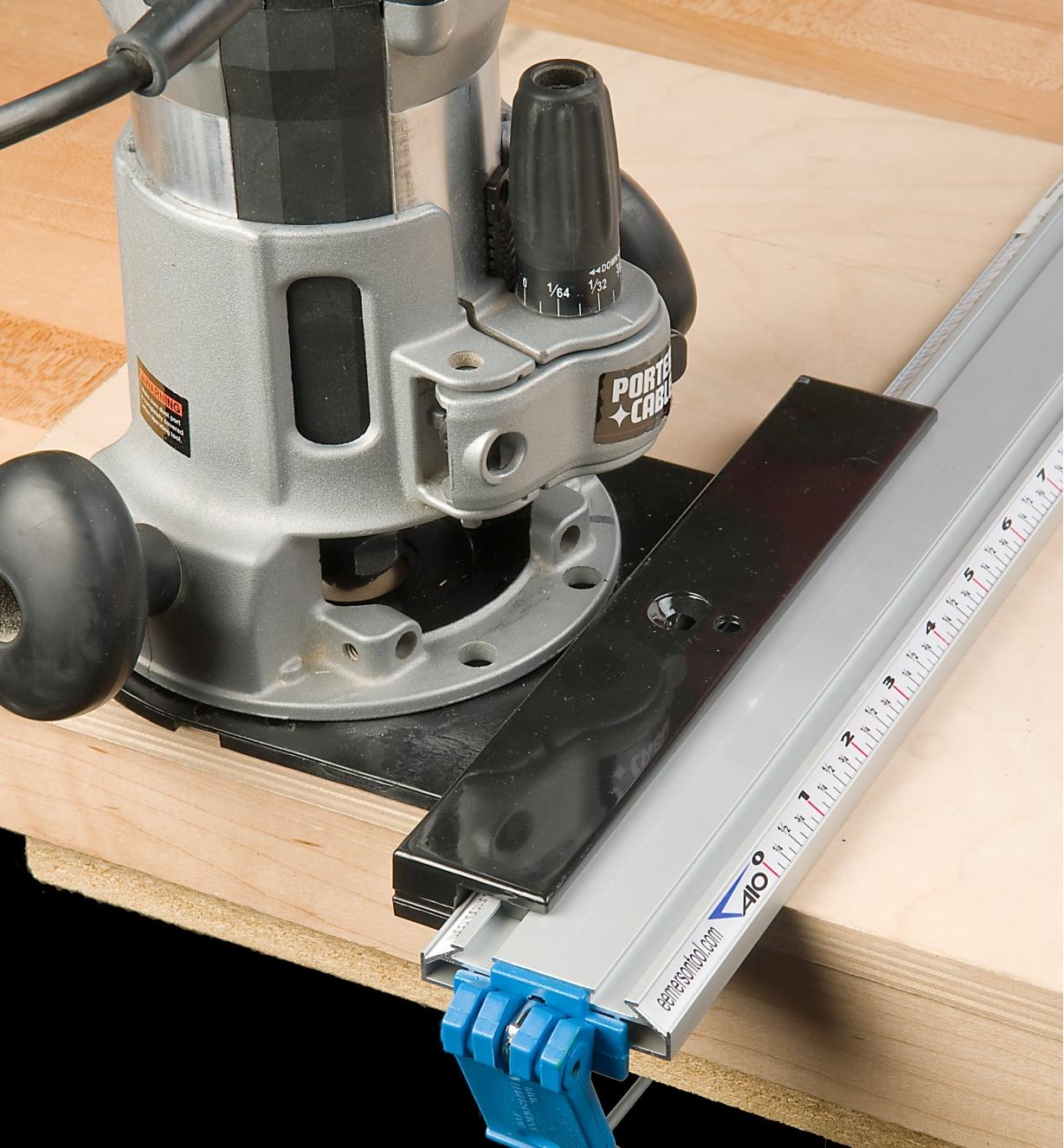 Low-profile tool guide in use with a router plate and router