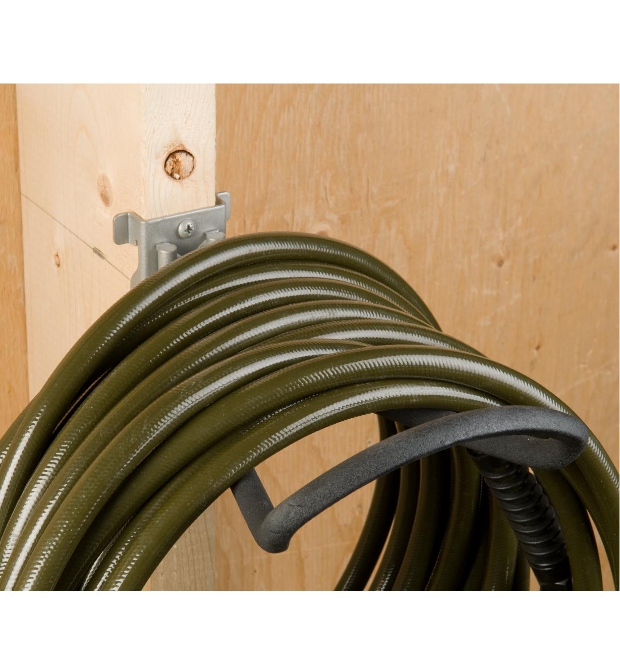 Loop Hook affixed to a stud, holding a hose